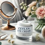 A jar of Ceylan Eye Cream placed on a marble countertop next to fresh flowers and a mirror.